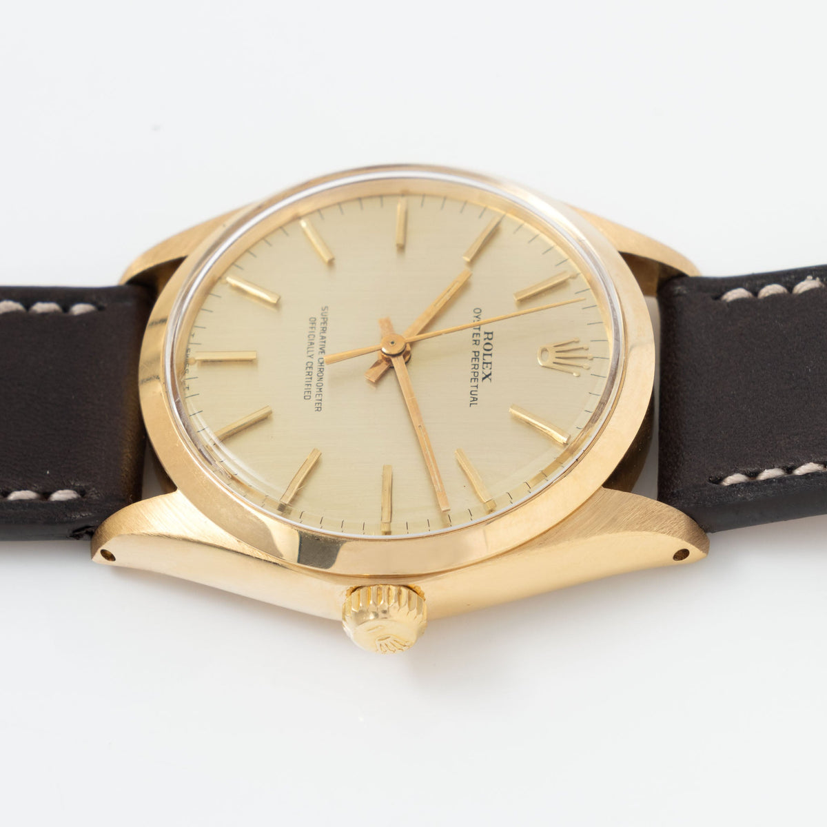 Rolex Oyster Perpetual Vertical brushed Champagne Dial in 18 k Yellow Gold ref 1002