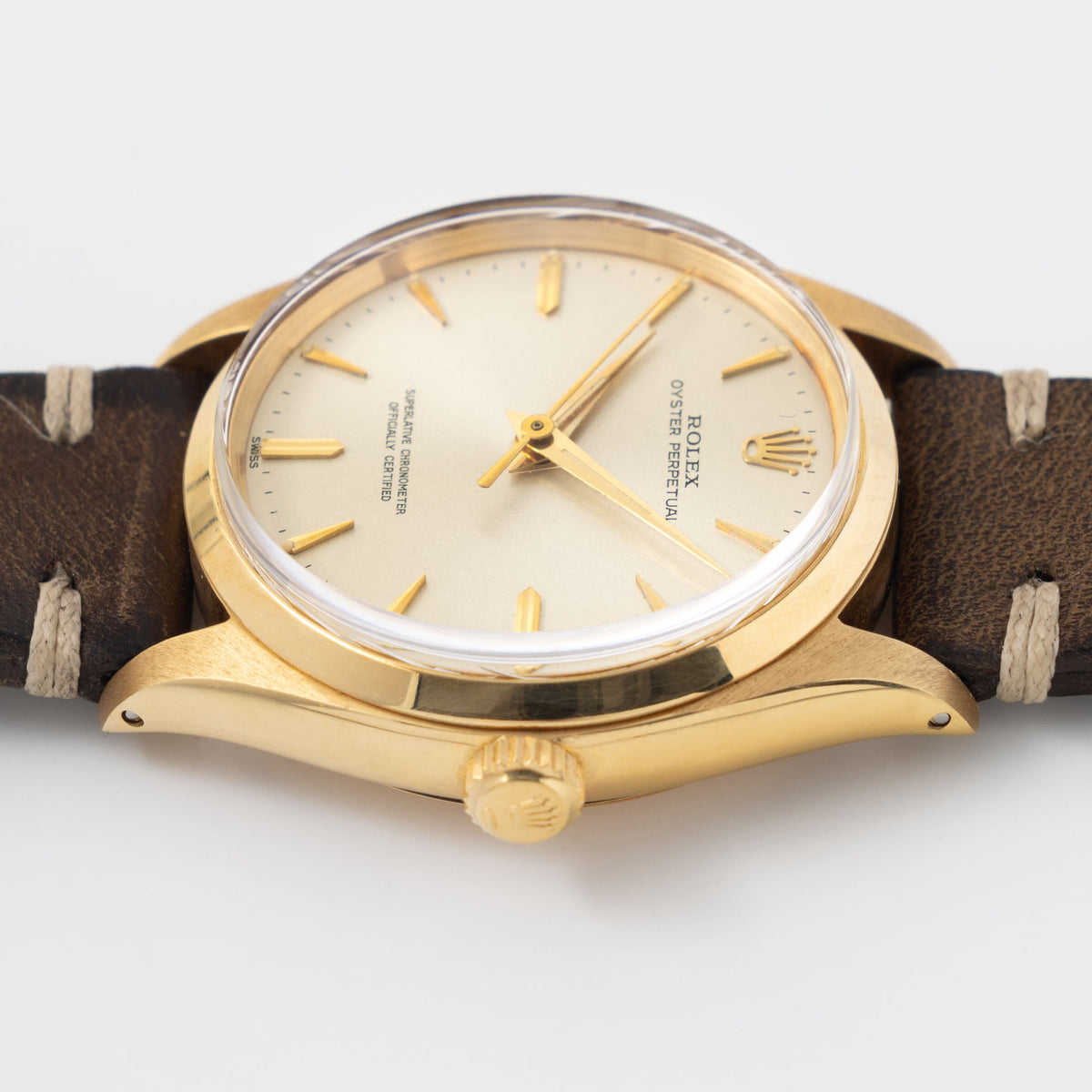 Rolex Oyster Perpetual 1002 Silver Soleil Swiss Only Dial in 18 k yellow gold Coca Cola