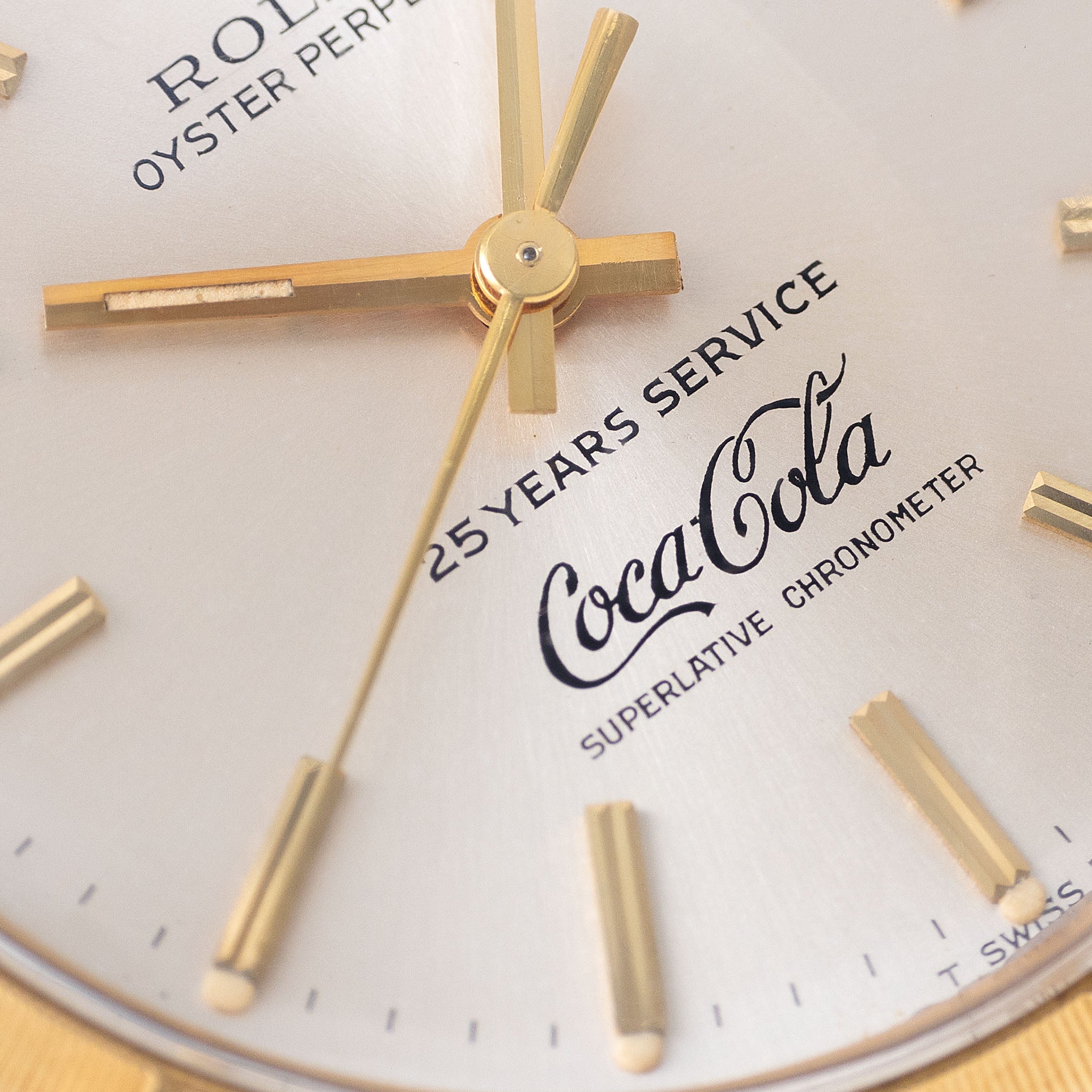 Rolex Oyster -Perpetual  silver "25 years Coca Cola service " logo dial   in 18 k yellow gold  with original double punched papers ref 1003