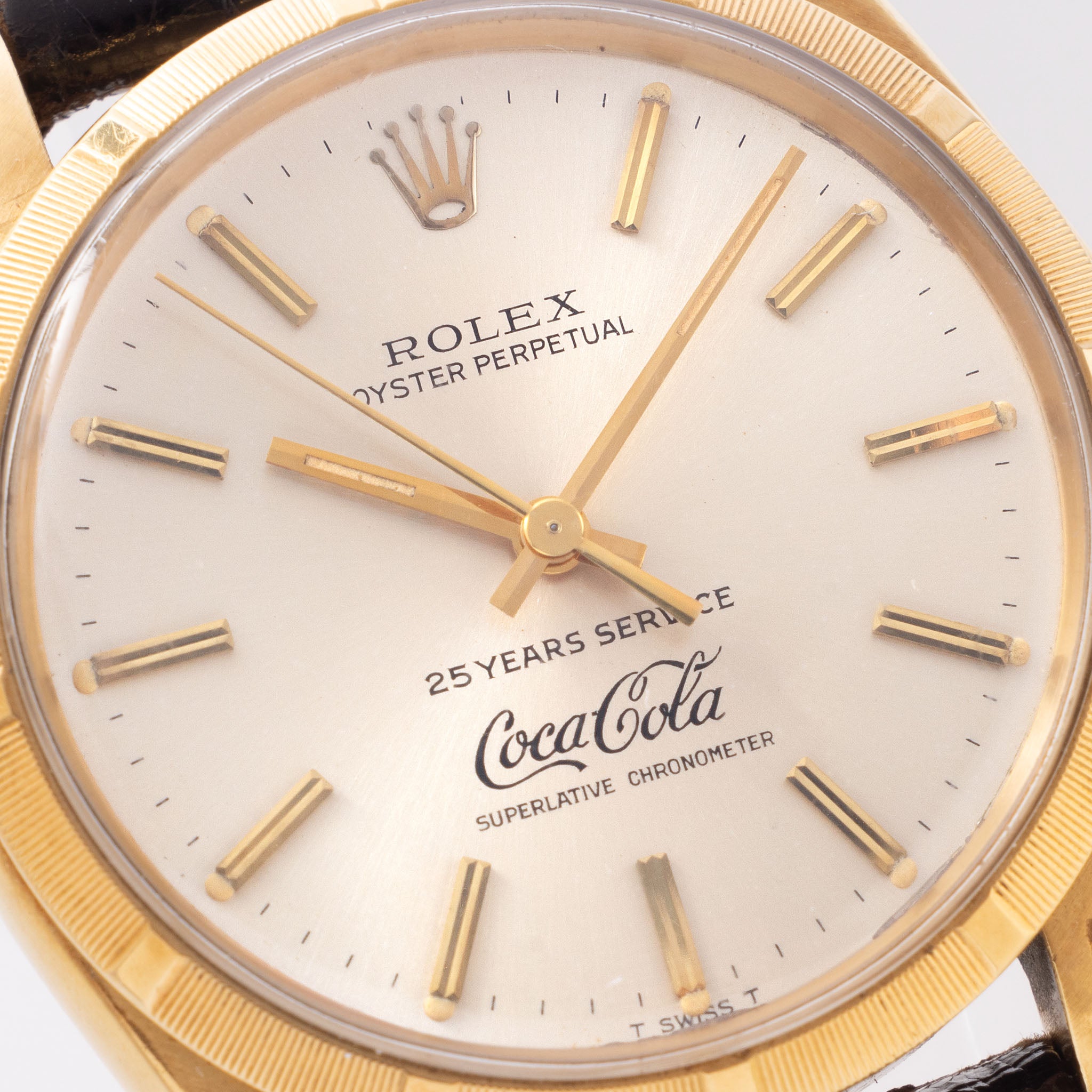 Rolex Oyster -Perpetual  silver "25 years Coca Cola service " logo dial   in 18 k yellow gold  with original double punched papers ref 1003